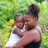 Woman holds daughter in Dominica in the aftermath of Hurricane Maria