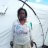 Woman standing in front of ShelterBox tent in Barbuda