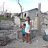 Mother and son stand outside destroyed home after Typhoon Mankhut in the Philippines