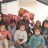 Large Syrian family sit together in displacement camp