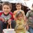 Children in a displacement camp in Syria hold a solar light