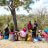People sitting and talking under the shade of a tree in Kenya