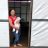 woman in the Philippines standing at her door with her baby