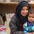 Girl holds toddler in Syria