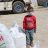child in Syria wearing a mask next to ShelterBox aid