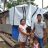 A Filipino family of 5 posing outside their damaged home