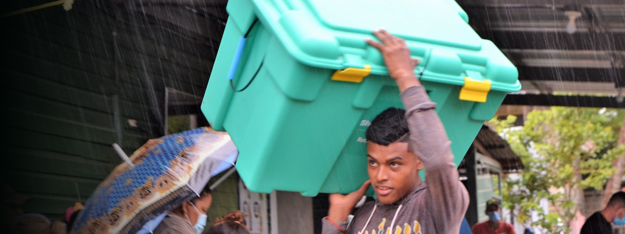 Man carrying a green shelterbox