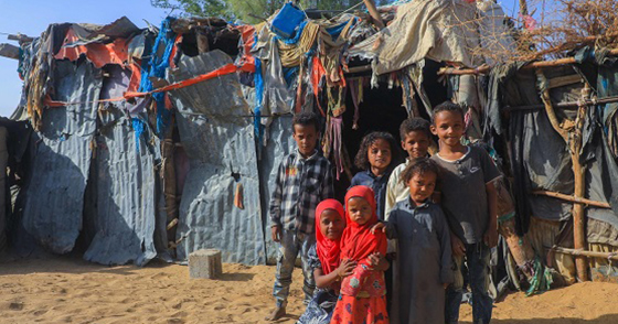 Yemeni children in front of a makeshift shelter